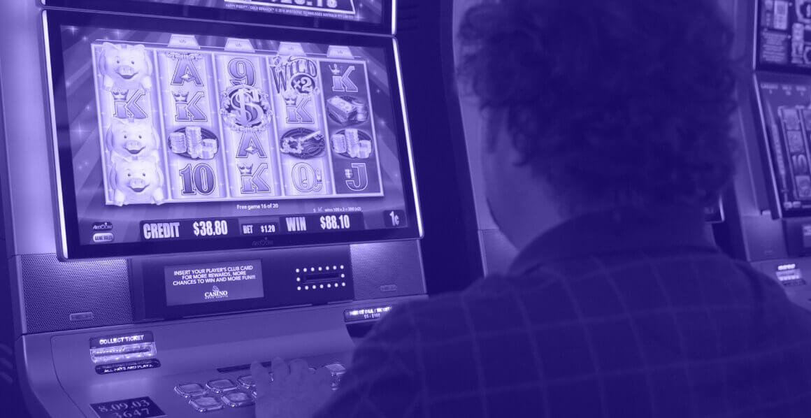 Player sitting at slot machine.
